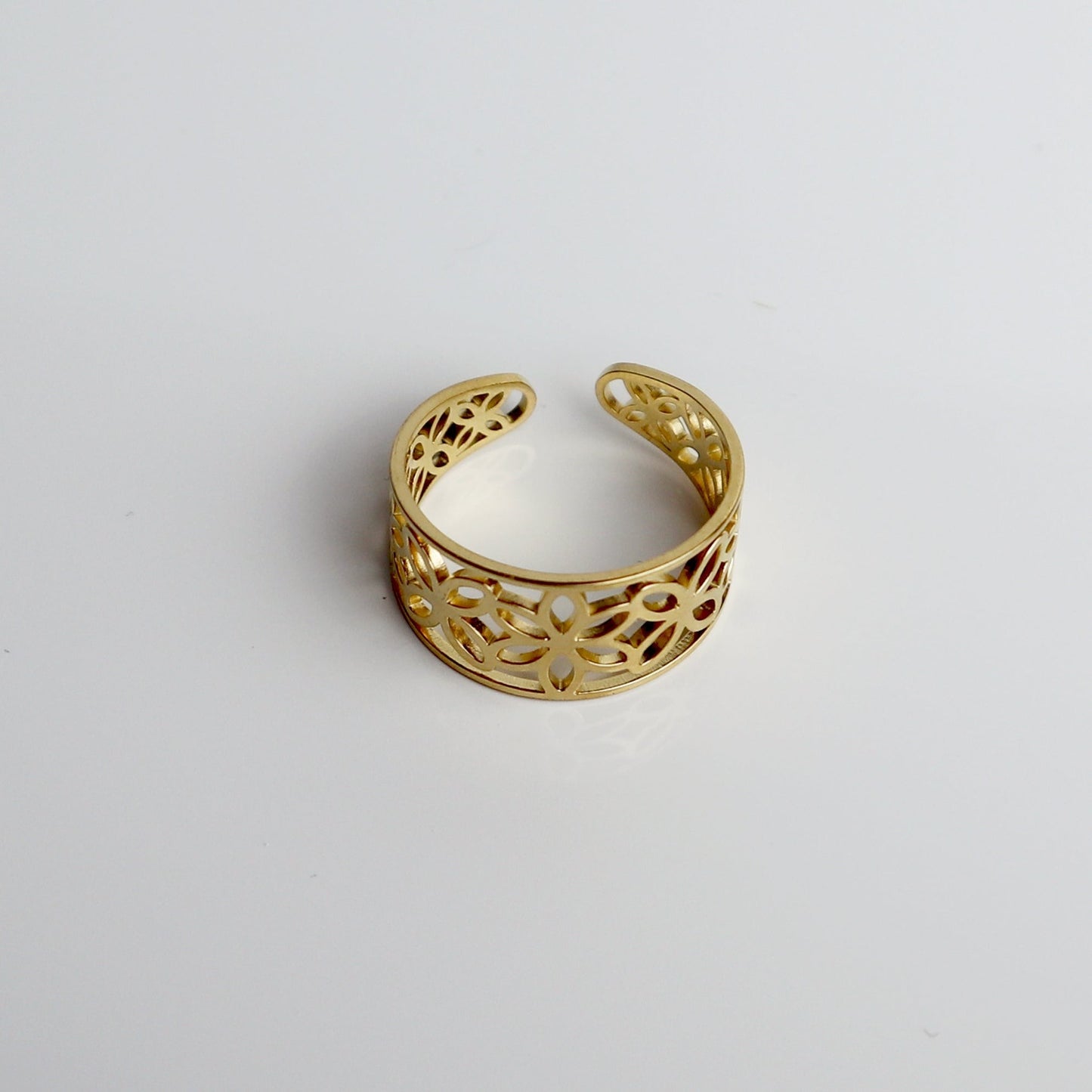 Drupt verstelbare gouden ring met een elegant opengewerkt bloemmotief voor een verfijnde uitstraling.